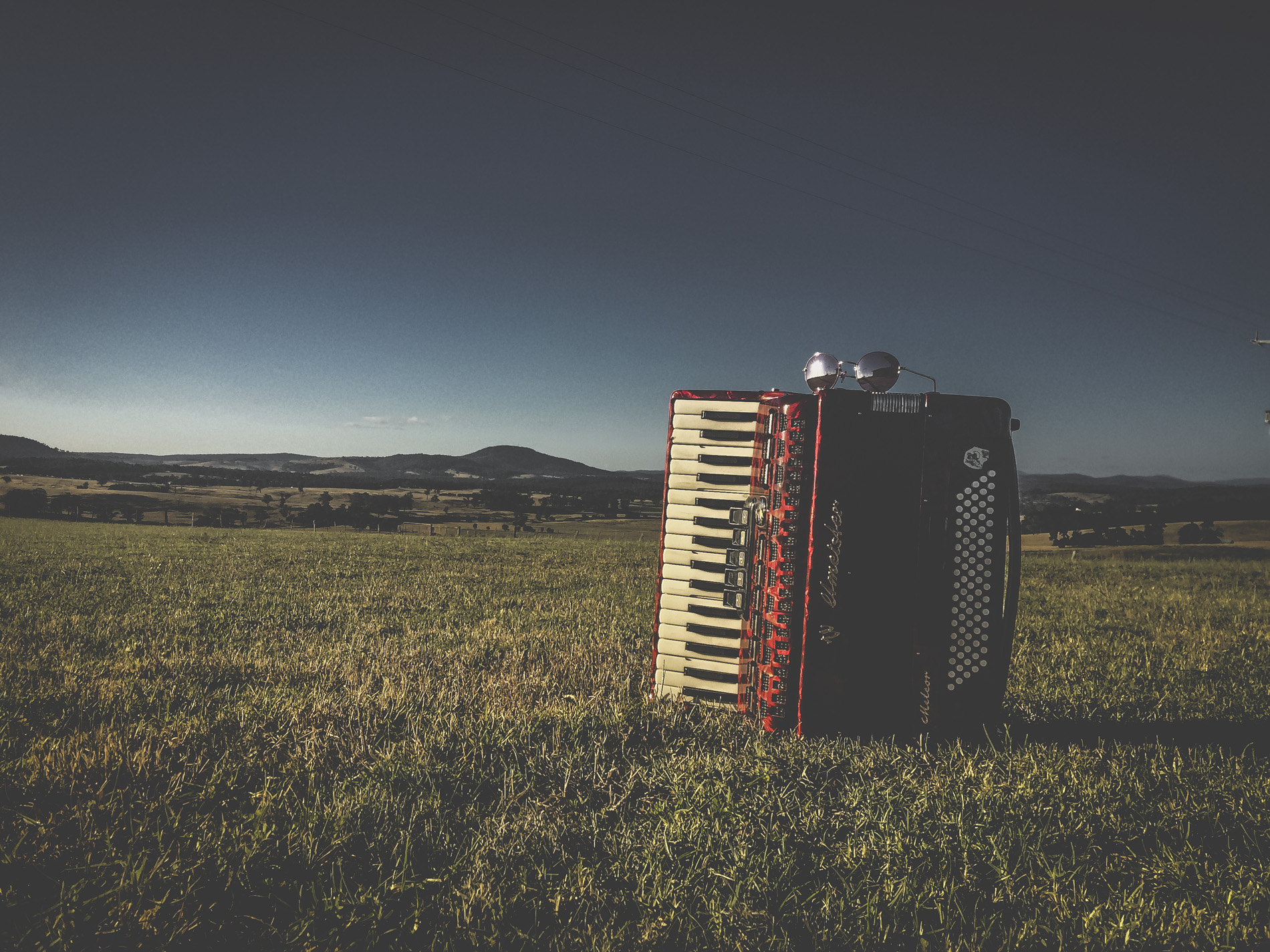 Czerwony Akordeon Red piano accordion in the landscape Aldona Kmiec Polish Art Photographer